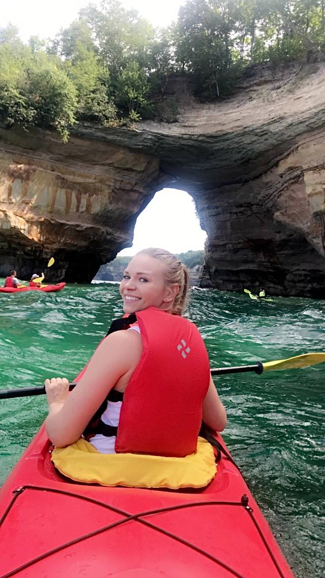 Student smiling for photo in kayak